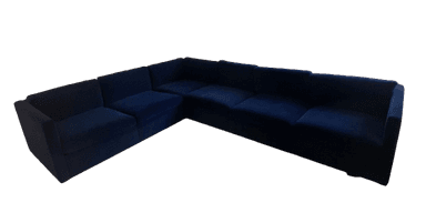 A dark blue, multi-seat sectional sofa with a low profile and blocky arms. It appears to be upholstered in a soft fabric, possibly velvet, and is configured in an L-shape. — 3D model