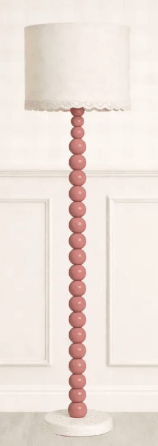 A tall floor lamp featuring a column made of uniformly sized pink beads, a round white base, and a cream fabric drum shade with a delicate lace trim. — 3D model