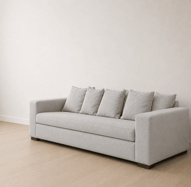 A modern three-seater sofa upholstered in a light gray woven fabric, featuring a streamlined rectangular form, square track arms, and four loose back cushions. The sofa sits on short, dark, recessed block feet. — 3D model