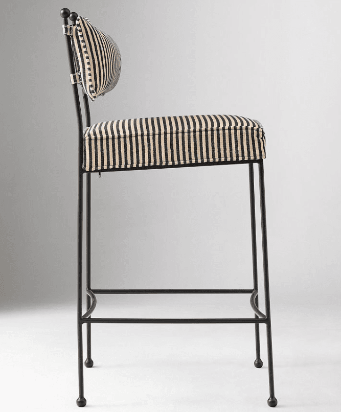A contemporary bar stool featuring a slender black metal frame and striped upholstered seat and backrest. The design includes an integrated footrest and ball-tipped feet. — 3D model