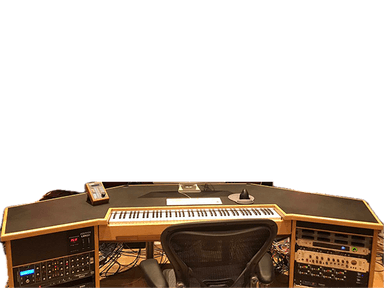 A purpose-built music studio production desk featuring a multi-faceted dark gray work surface with light wood trim. It includes an integrated keyboard tray and rack-mount bays for audio equipment. The desk has an angled design to optimize workflow and provides space for studio monitors and other gear. — 3D model