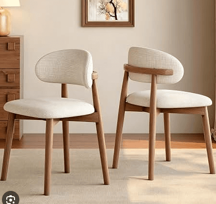 A modern dining chair featuring a light-colored upholstered seat and a distinctly curved, upholstered backrest, supported by a warm-toned wooden frame with slender, tapered legs. The design emphasizes clean lines and ergonomic comfort. — 3D model