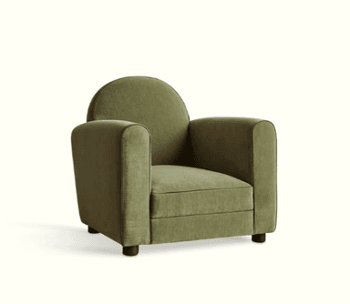 A plush armchair with a rounded back and square armrests, upholstered in a textured olive green fabric. It features subtle piping detail in a darker shade along the edges of the seat cushion, armrests, and back. The armchair is supported by short, dark wooden legs. — 3D model