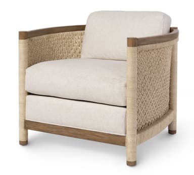 An upholstered armchair featuring a blend of natural materials. The chair has a sturdy wooden frame, likely oak or similar light-toned wood, visible on the base and as a top rail for the arms and back. The side panels and back are intricately covered with a tightly woven, natural jute or rope material, creating a textured, almost basket-like appearance. It is fitted with thick, comfortable cushions for the seat and back, upholstered in a light, off-white or cream-colored fabric, suggesting a linen or textured blend. The overall aesthetic is relaxed yet refined, suitable for various contemporary or coastal interior designs. — 3D model