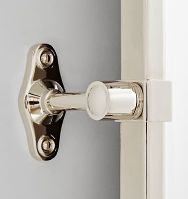 An oval-shaped wall-mounted mirror featuring a slim, polished metal frame and a pivoting mechanism. The mirror is attached to a decorative wall bracket, allowing it to be tilted for adjustable viewing angles. The metallic finish appears to be polished nickel or chrome, providing a sleek and contemporary aesthetic. — 3D model