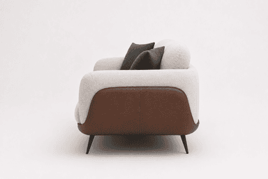 A modern two-seater sofa featuring a clean, minimalist design with a two-tone upholstery. The main body and back cushions are upholstered in a light, textured fabric, while the lower side panels and base are covered in a contrasting brown leather-like material. It has rounded armrests and sits on slender, tapered dark metal legs. — 3D model