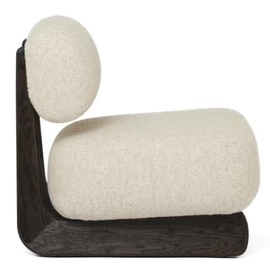 A modern, low-profile lounge chair featuring plush, off-white bouclé upholstery and a distinctive dark-stained wooden frame. The chair consists of a thick, cushioned seat and a separate, curved backrest, both generously upholstered. The solid wooden frame acts as both the base and the support for the backrest, showcasing smooth, rounded lines and a visible wood grain. — 3D model