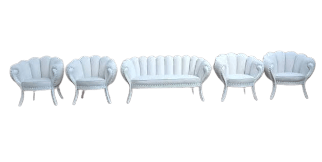 An elegant, upholstered loveseat featuring a distinctive shell-back design with vertical channel tufting. It has integrated armrests, nailhead trim along the base and outer arms, and is supported by four short, curved legs. The upholstery is a light, possibly white, color. — 3D model