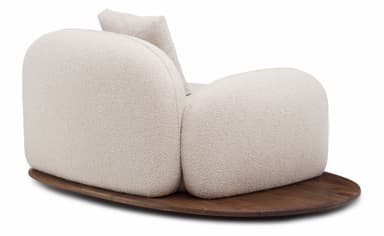 An armchair with a rounded, organic form, featuring a textured boucle fabric upholstery in a light neutral color. It rests on a dark, solid wood base with a rounded, elliptical shape. The armchair has a distinctively plush and inviting appearance, with a low profile and a single, attached back cushion that mirrors the curvature of the main body. — 3D model