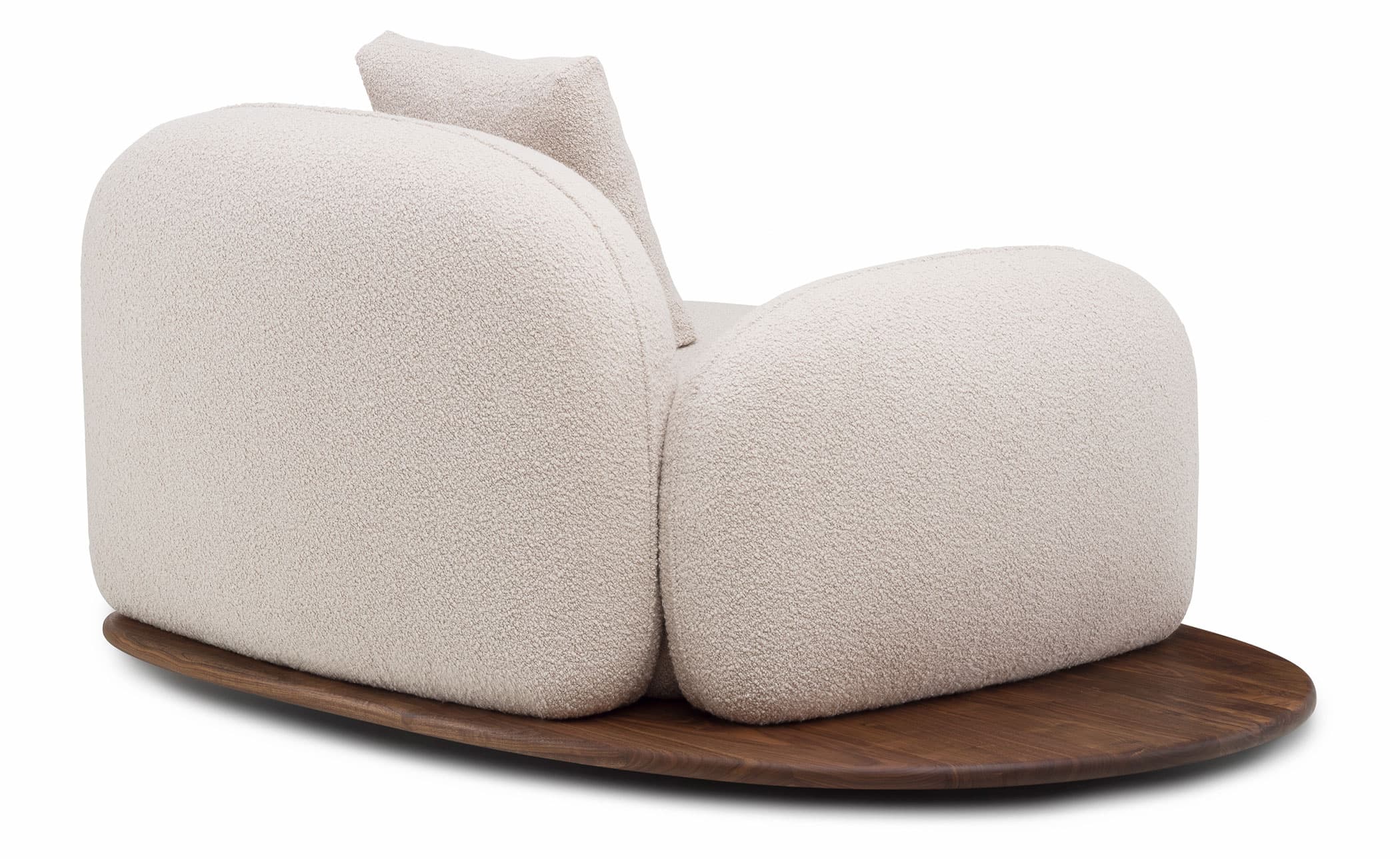 An armchair with a rounded, organic form, featuring a textured boucle fabric upholstery in a light neutral color. It rests on a dark, solid wood base with a rounded, elliptical shape. The armchair has a distinctively plush and inviting appearance, with a low profile and a single, attached back cushion that mirrors the curvature of the main body. — 3D model