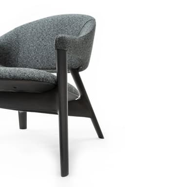 A modern armchair with a curved silhouette. The chair features a dark wooden frame and upholstered seat and back in a speckled grey fabric. The armrests are integrated into the frame, flowing from the backrest to the front. — 3D model