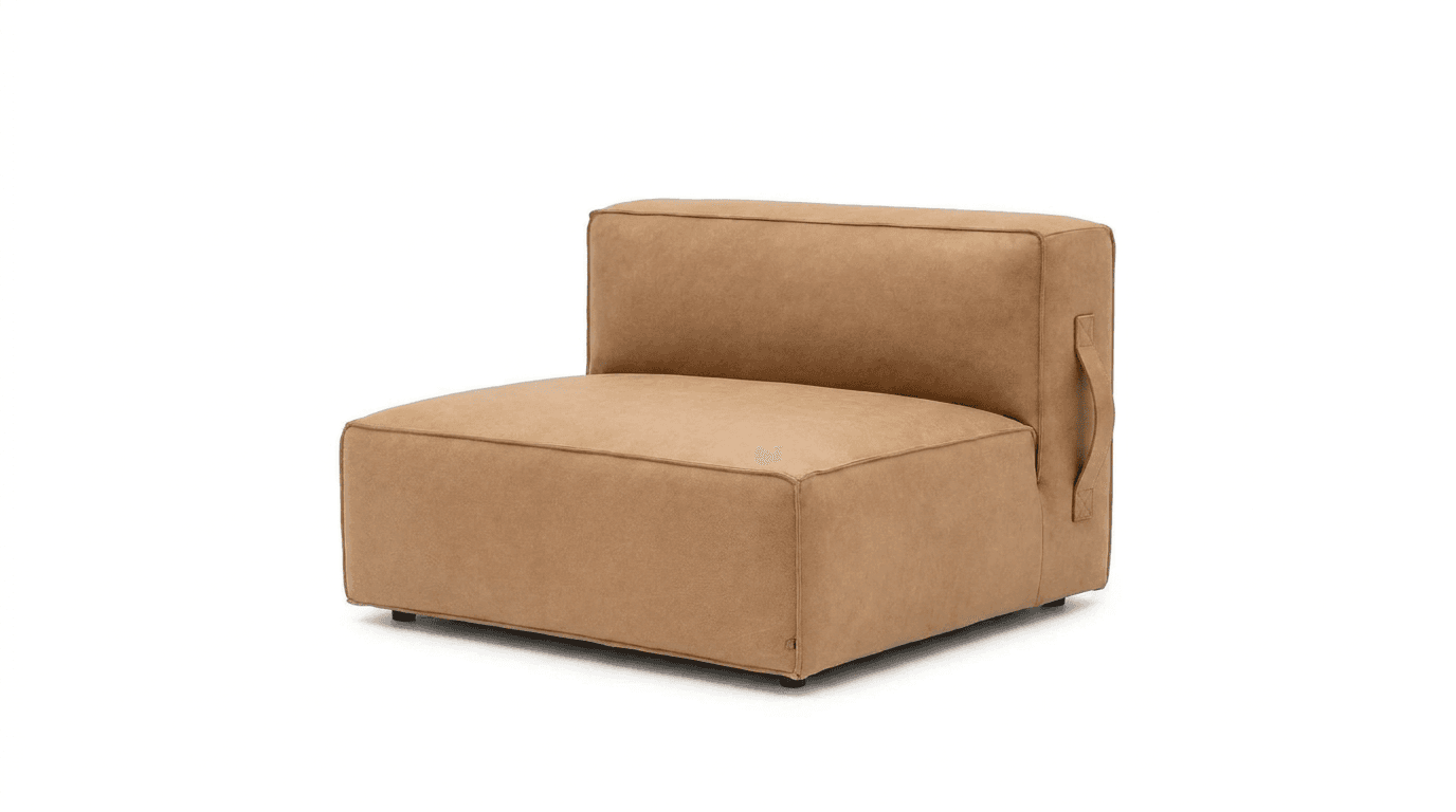 A contemporary armless lounge chair upholstered in light brown or tan leather, featuring a minimalist blocky design. The piece includes integrated seat and back cushions with visible piping along the edges. A discreet handle on one side suggests its modular nature or ease of repositioning. The chair sits low to the ground on small, almost invisible feet. — 3D model