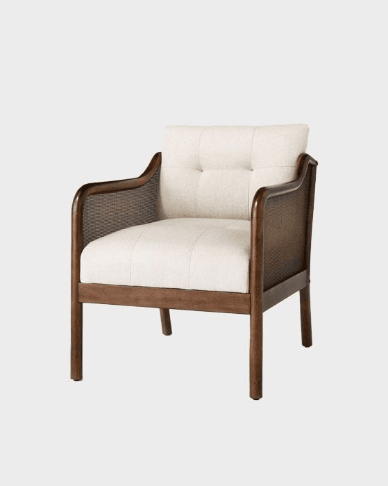 An upholstered armchair featuring a dark brown wood frame, cane webbing side panels, and light-colored fabric cushions. The back cushion is button-tufted, and the seat cushion is smooth. The armrests are curved and made of solid wood. The chair stands on four straight, tapered wooden legs. — 3D model