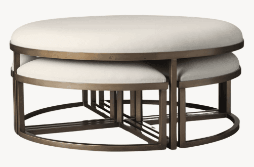 A set of nesting ottomans with oval upholstered tops and a metal frame. The larger ottoman is positioned above smaller ottomans which fit underneath. — 3D model