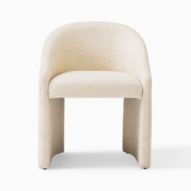 A compact, contemporary barrel-back accent chair, fully upholstered in a light beige or cream textured fabric, featuring a continuous curved backrest that integrates into armrests, and a solid plinth-style base. — 3D model