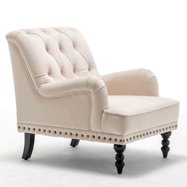 A traditional upholstered armchair featuring a light cream fabric, rolled armrests, a tufted backrest, and decorative nailhead trim along the base. The chair stands on dark-finished legs, with turned spool-shaped legs at the front and tapered saber legs at the rear. — 3D model