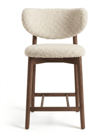 A bar stool with a curved backrest and a separate seat cushion. The frame and legs are made of dark wood, with a distinct grain. The upholstery on the backrest and seat appears to be a textured, plush fabric, possibly sherpa or a similar material, in an off-white or cream color. The stool features a wooden stretcher connecting the legs for stability. — 3D model