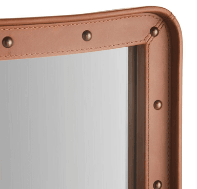 A tall, rectangular wall mirror featuring a frame constructed from rich, medium brown leather, accented with numerous brass-toned studs along its inner and outer edges. The mirror glass is plain, and the frame exhibits softly rounded corners, contributing to a refined yet rugged aesthetic. — 3D model