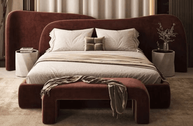 An upholstered daybed featuring a continuous, seamless design, covered in a reddish-brown velvet-like fabric. It comprises a curved seating surface that flows into a U-shaped base, paired with an integrated, wave-like backrest that offers support. — 3D model