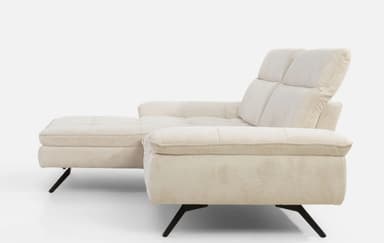 A contemporary sectional sofa with a chaise lounge extension. The sofa features plush, upholstered cushions with a textured fabric. The back cushions have horizontal stitching, and the seat cushions have a tufted grid pattern. It is supported by slender, angled black metal legs. — 3D model