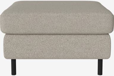 A rectangular ottoman with a plush, upholstered top and a slightly recessed base, supported by four slender, dark-colored legs. The upholstery has a textured, woven appearance. — 3D model