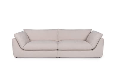A modern, low-profile sofa with a modular design, featuring two seat cushions and plush back cushions. The sofa has rounded edges and appears to be upholstered in a light-colored fabric. It is presented on a black background. — 3D model