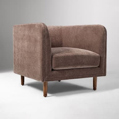 A contemporary upholstered club armchair featuring a single, removable seat cushion, integrated flared arms, and a low back, all covered in a textured, brown fabric. The chair stands on four tapered wooden legs. — 3D model
