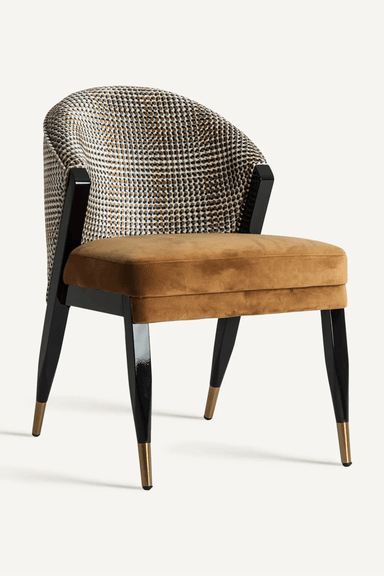An armchair with a curved backrest upholstered in a patterned fabric, and a seat upholstered in brown velvet. The chair has four tapered legs with a glossy black finish and brass-colored caps at the bottom. — 3D model