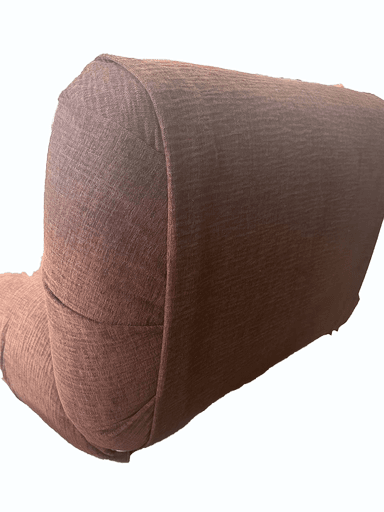 A contemporary, armless armchair with a low profile and a single padded seat and backrest. The upholstery has a textured weave. The backrest features a single button tuft in the center. It rests on a dark, flat base. — 3D model
