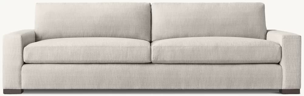 A contemporary two-seater sofa upholstered in a light beige, textured fabric. It features clean lines, square track arms, and a 'two-over-two' cushion configuration with removable seat and back cushions. The sofa sits on subtle, dark-colored block feet. — 3D model
