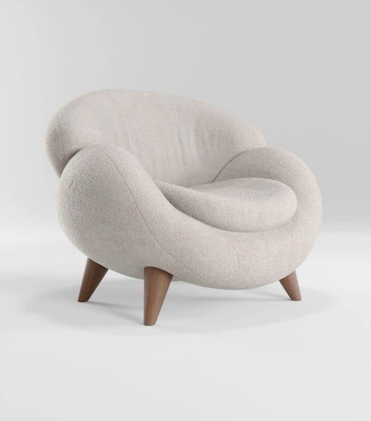 A contemporary, sculptural lounge chair upholstered in a light-colored, textured bouclé fabric, featuring an organic, rounded form and supported by four short, tapered wooden legs. — 3D model