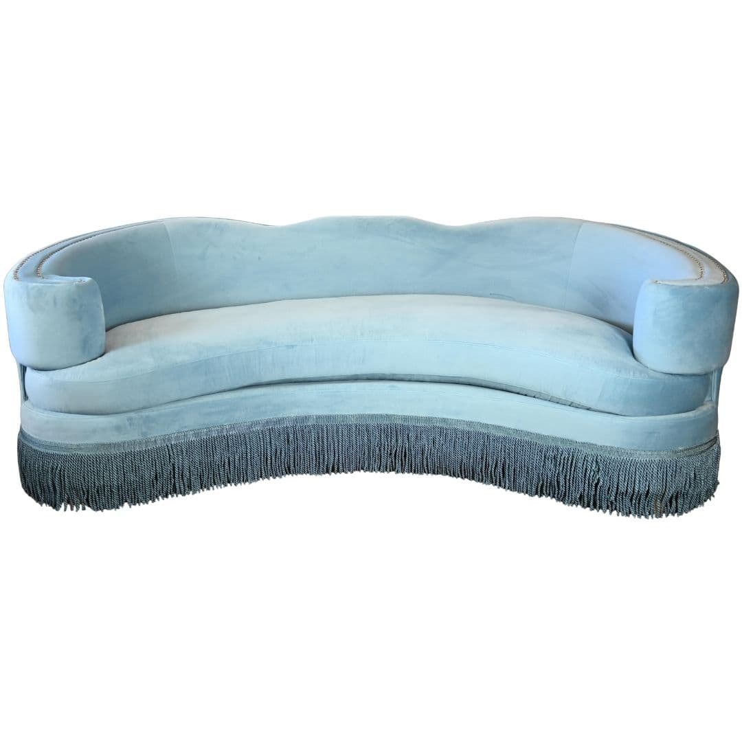 A vintage, pale blue sofa with a curved, serpentine back and rolled arms. It features a detailed fringe trim along the bottom base. The upholstery appears to be a soft, plush fabric, possibly velvet, with a lighter tone on the seat cushion. — 3D model