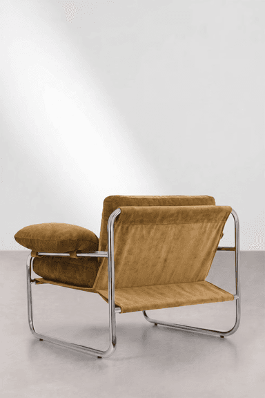 A modern lounge armchair featuring a polished tubular chrome frame and plush, warm brown upholstered cushions. The design evokes a Bauhaus aesthetic with its minimalist frame and deep, comfortable seating. — 3D model