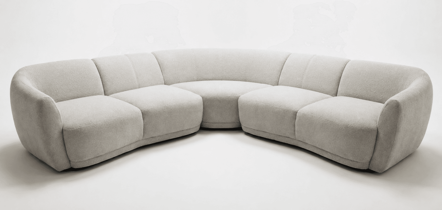 A light grey, modular sectional sofa with a distinctly curved form, upholstered in a textured, boucle-like fabric, featuring rounded edges and a low-profile design. — 3D model