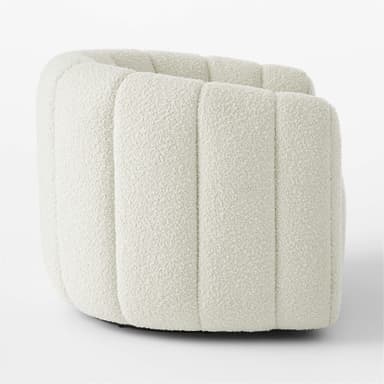 A cream-colored, rounded ottoman with vertical channel tufting across its exterior. The upholstery has a textured, boucle-like finish. The base appears to be dark and low-profile, supporting the cylindrical body of the ottoman. — 3D model