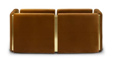 A contemporary two-seater sofa with a minimalist design. The sofa features a plush velvet upholstery in a warm brown hue. Its structure is characterized by clean lines, with substantial armrests and back cushions. Accents of polished brass or gold-toned metal are visible at the top of the armrests and between the back cushions, providing a luxurious contrast to the fabric. — 3D model