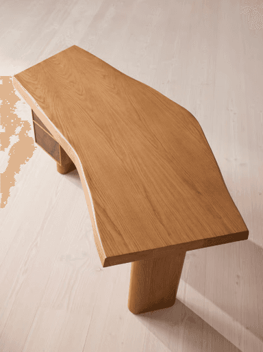 A contemporary desk featuring an irregularly shaped wooden tabletop supported by cylindrical legs and an integrated three-drawer pedestal. The main structure appears to be solid light-toned wood, possibly oak, while the drawer fronts are made from a contrasting darker burl wood veneer, adding a distinctive visual element. The design is minimalist and sculptural. — 3D model