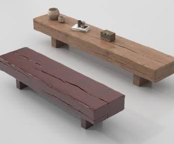 A sturdy, rectangular bench with a rustic aesthetic, featuring a thick, solid-looking seat supported by two simple block legs. — 3D model