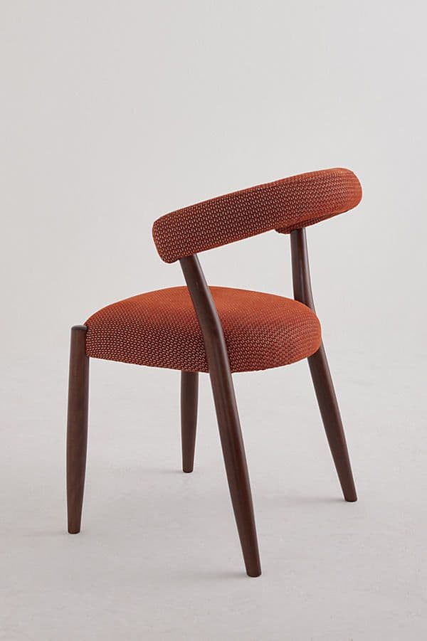 A contemporary upholstered chair featuring a curved backrest that seamlessly transitions into armrests, supported by a dark wood frame. — 3D model