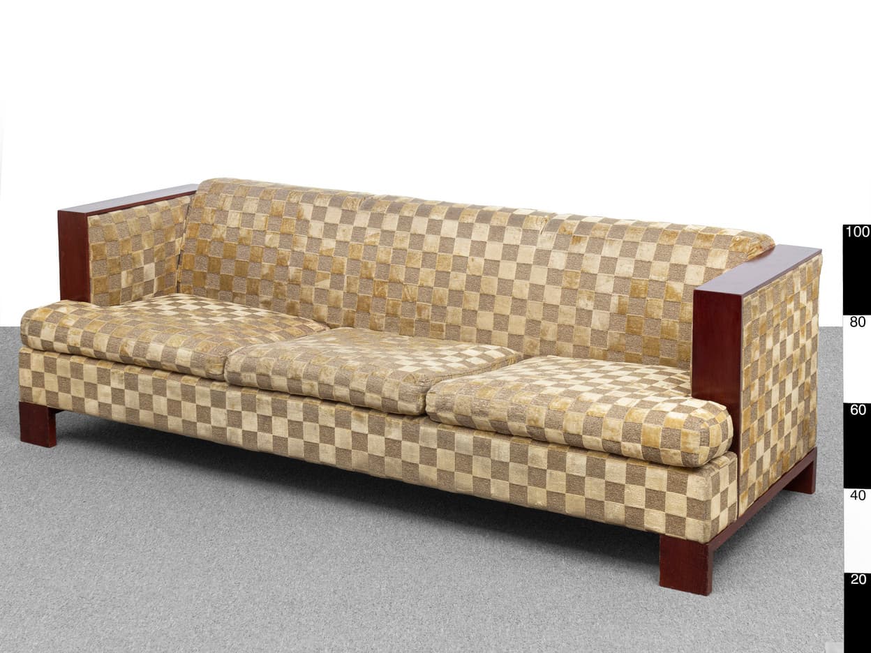 A three-seater sofa with a checkerboard pattern upholstery. It features dark wood armrests and a wooden frame, with the seat and back cushions appearing to be upholstered in a textured fabric. The sofa has a contemporary design with clean lines. — 3D model