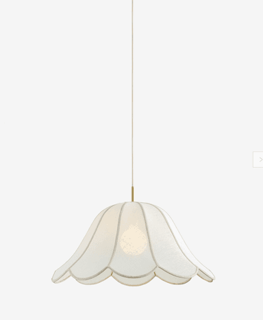 A contemporary pendant light featuring a scalloped, bell-shaped shade crafted from white fabric, suspended from a brass canopy by a white cord. A single light bulb is visible within the translucent shade. — 3D model