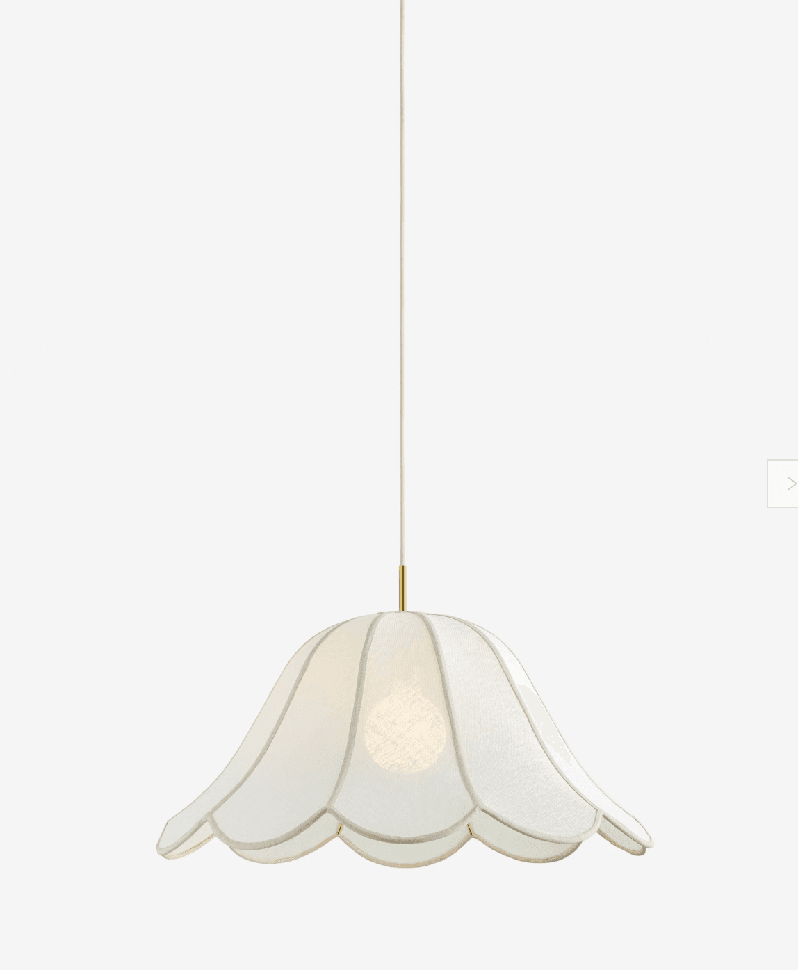 A contemporary pendant light featuring a scalloped, bell-shaped shade crafted from white fabric, suspended from a brass canopy by a white cord. A single light bulb is visible within the translucent shade. — 3D model