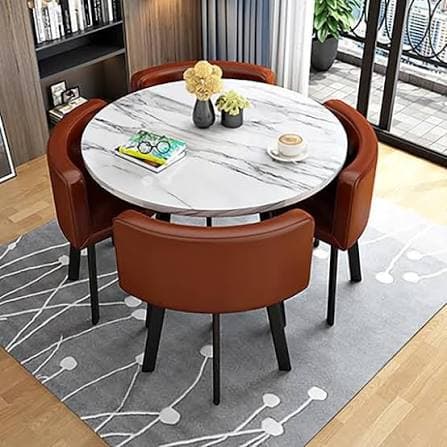 A modern dining set consisting of a round dining table with a white marble-patterned top and black metal legs, accompanied by four matching dining chairs. The chairs feature a barrel-back design, upholstered in a tan or light brown material, and supported by slender black metal legs. — 3D model