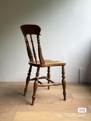 A vintage wooden side chair featuring a spindle back, turned legs, and a saddle-shaped seat, showcasing natural wood grain and signs of age. — 3D model