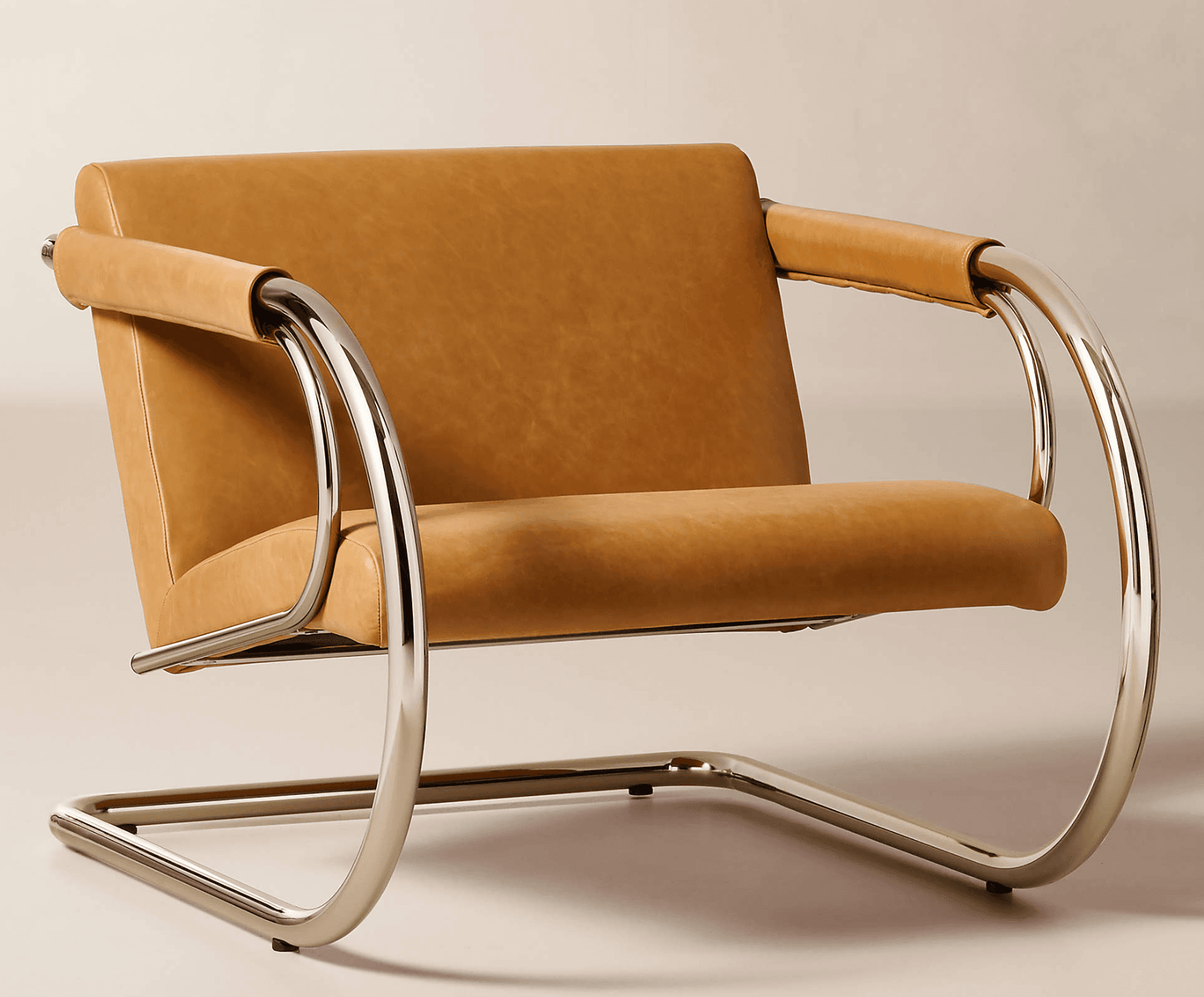 A modern lounge chair featuring a distinctive cantilevered frame constructed from polished chrome-plated tubular steel. The seat, backrest, and armrests are upholstered in smooth, saddle tan leather, providing a sleek contrast to the metallic frame. The armrests are designed with rolled leather wraps around the chrome tubes. The chair exhibits a clean, architectural aesthetic. — 3D model