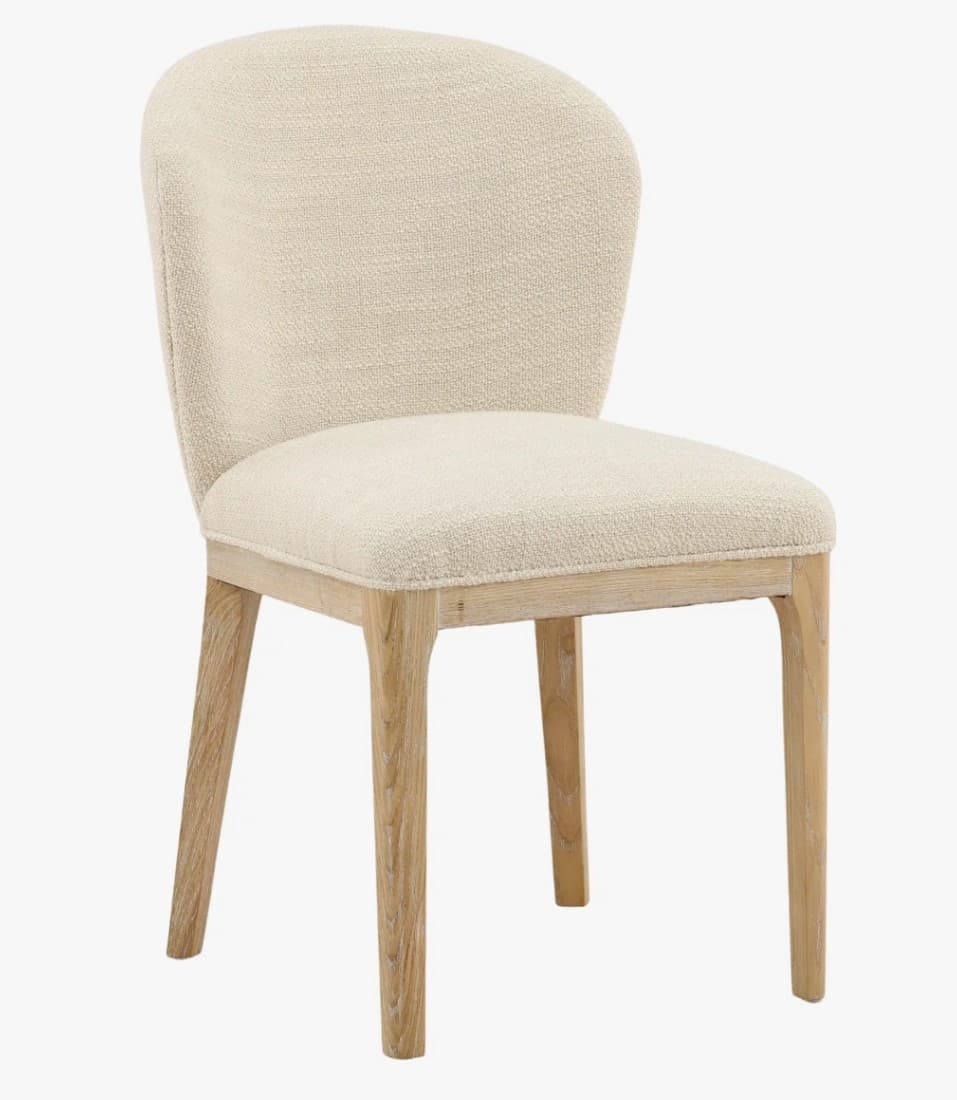 A upholstered dining chair with a curved backrest and wooden legs. The seat and back are covered in a textured, light-colored fabric. The legs are straight and made of light-colored wood, with a visible grain pattern. — 3D model