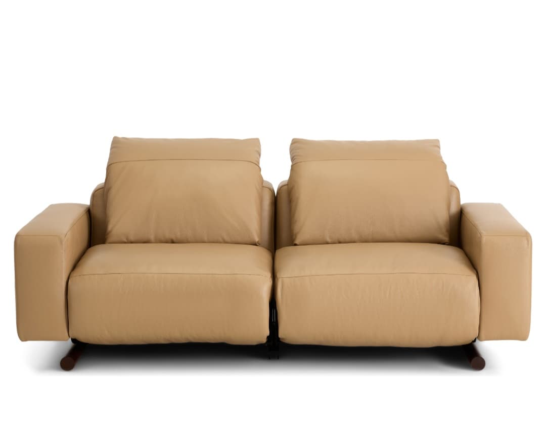 A modern two-seater reclining sofa, upholstered in smooth, light tan leather. It features two individual seats, each with a plush back cushion and integrated armrests. The sofa stands on small, dark-colored cylindrical feet, offering a minimalist profile. — 3D model