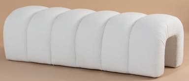 A contemporary upholstered bench featuring a distinctive segmented design, with multiple rounded, tubular sections forming the seating surface. The bench is finished in a light-colored, textured fabric, likely boucle, and has a soft, sculptural aesthetic. — 3D model