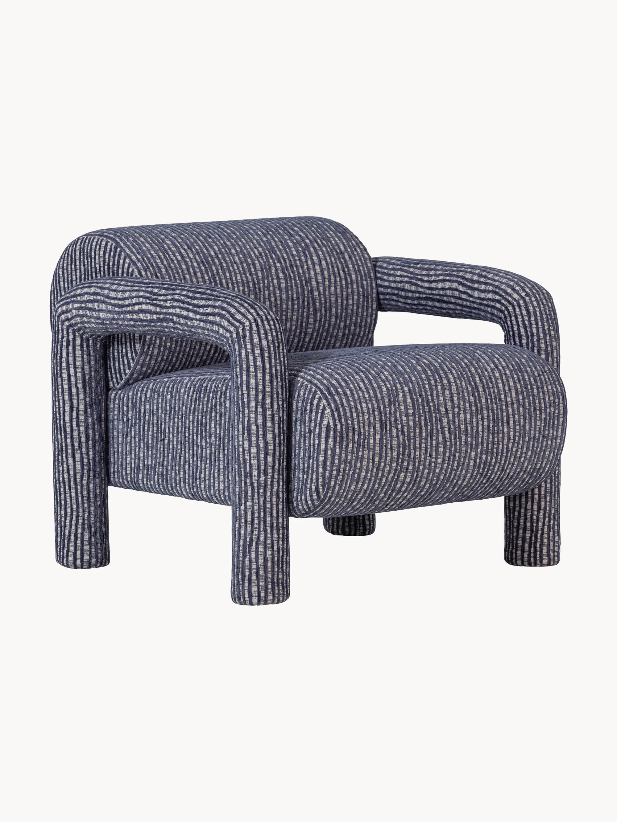 A contemporary armchair upholstered in a textured fabric with a vertical stripe pattern. The armchair features a rounded, monolithic design with integrated arms that flow into the seat and backrest. It is supported by four block-style legs, also upholstered in the same fabric. — 3D model