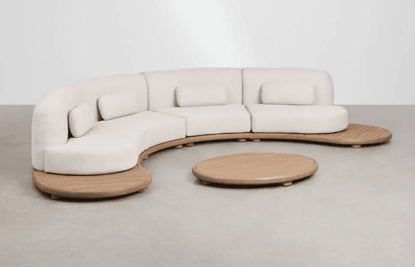 A modular, curved sofa with a low profile, featuring a light-colored upholstered seating area and backrests. Integrated wooden platforms extend from the sides of the sofa, serving as side tables or extensions. A complementary circular wooden coffee table is positioned in front of the sofa. The design appears to be modern and possibly intended for outdoor use due to the wooden elements. — 3D model